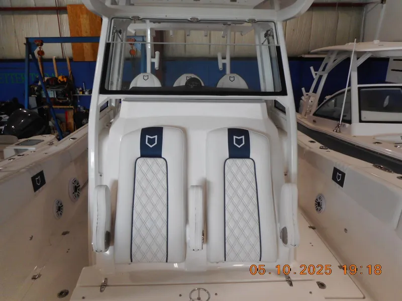 Slide: The Image of 2025 Sea Fox 328 Commander boat interior with dual seats and console. - 22