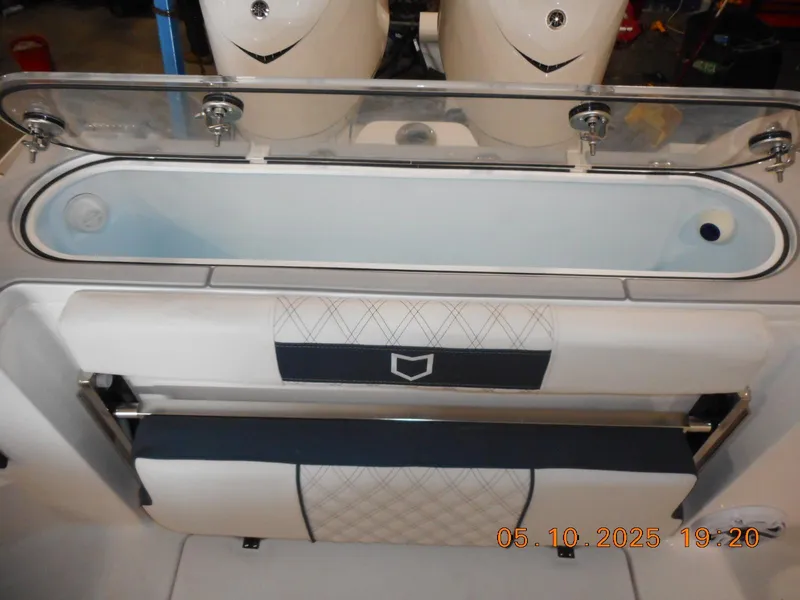 Slide: The Image of 2025 Sea Fox 328 Commander boat interior with seating and storage compartment. - 27