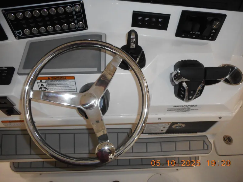 Slide: The Image of Steering wheel and controls of 2025 Sea Fox 328 Commander boat. - 29
