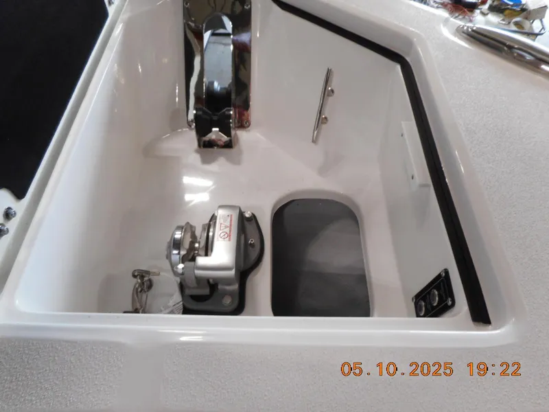 Slide: The Image of Anchor compartment of 2025 Sea Fox 328 Commander boat, featuring winch and cleat. - 32