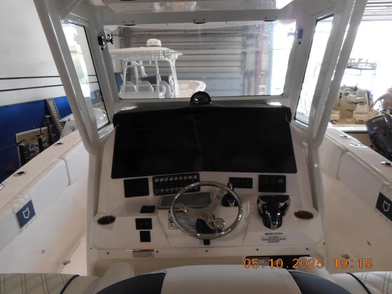 Slide: The Image of 2025 Sea Fox 328 Commander boat dashboard with steering wheel and controls. - 7