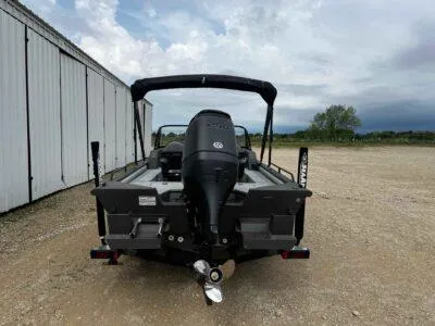 Slide: The Image of 2025 SeaArk ProCat 240 boat, rear view, parked outdoors near a building. - 5