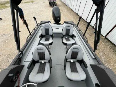 Slide: The Image of 2025 SeaArk ProCat 240 boat interior with four seats, gray and black design. - 6