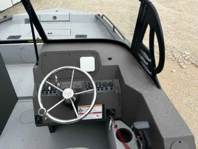 Slide: The Image of 2025 SeaArk ProCat 240 boat dashboard with steering wheel and control panel. - 7