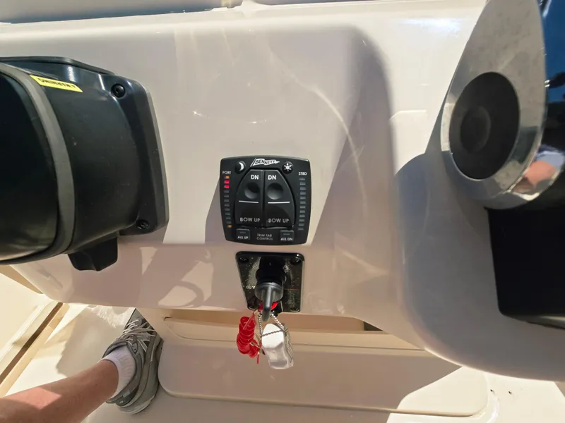 Slide: The Image of 2023 Grady-White Fisherman 180 boat dashboard with control panel and safety lanyard. - 12