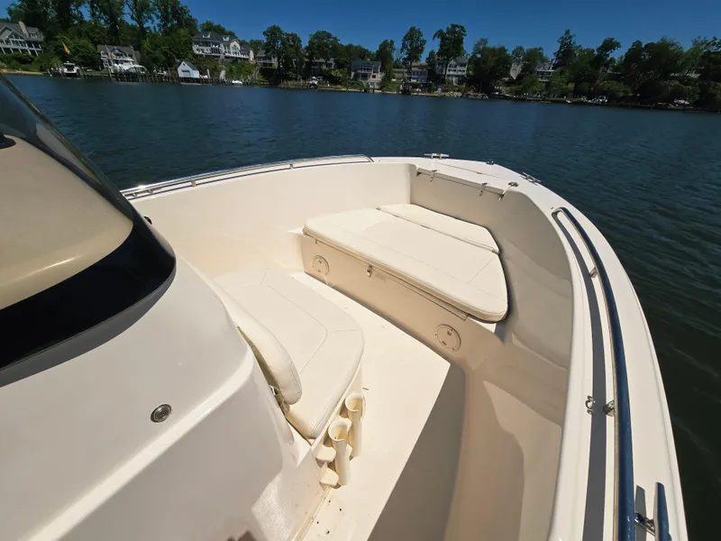 Slide: The Image of 2023 Grady-White Fisherman 180 boat interior with seating, on a calm lake. - 13