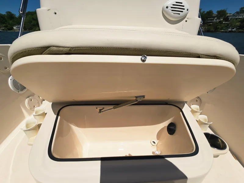 Slide: The Image of 2023 Grady-White Fisherman 180 boat storage compartment open under sunny sky. - 16