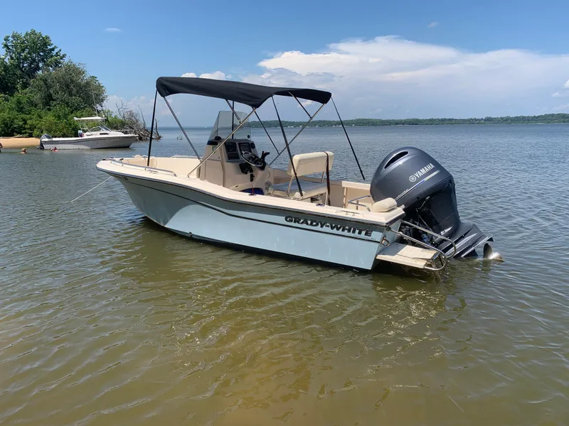 Slide: The Image of 2023 Grady-White Fisherman 180 boat with Yamaha engine on calm water. - 2