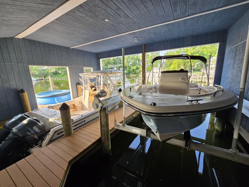 Slide: The Image of 2023 Grady-White Fisherman 180 boat docked in a covered marina. - 35