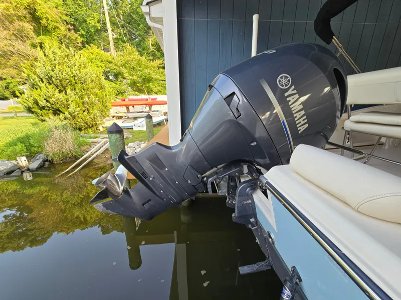 Slide: The Image of 2023 Grady-White Fisherman 180 with Yamaha outboard motor docked by a blue building. - 39