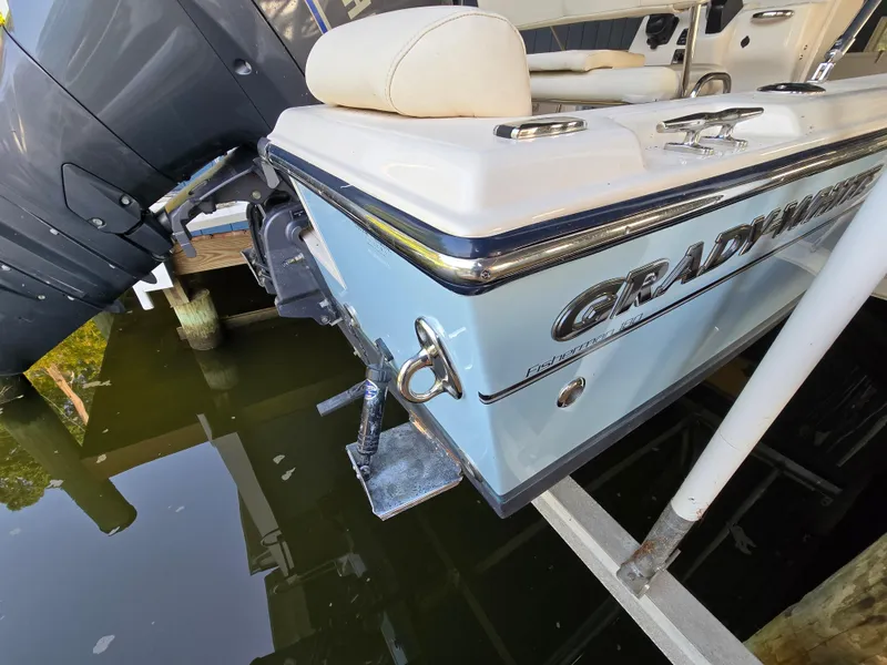 Slide: The Image of 2023 Grady-White Fisherman 180 boat stern view with motor, docked on water. - 40
