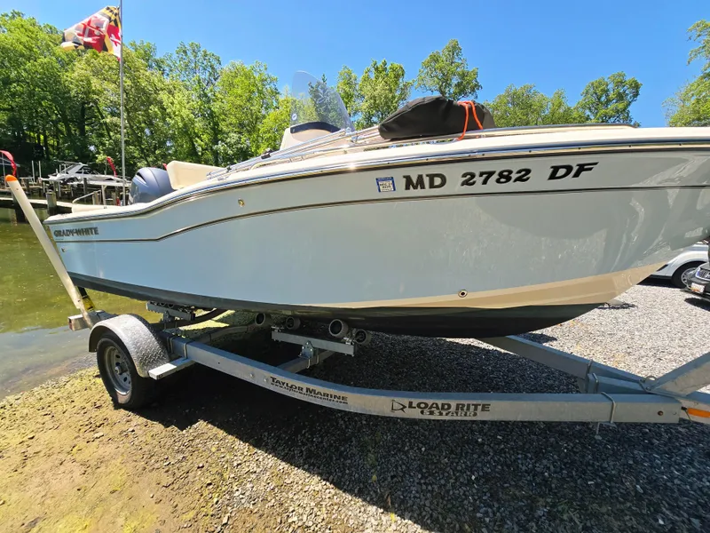 Slide: The Image of 2023 Grady-White Fisherman 180 boat on trailer, parked near water, sunny day. - 6