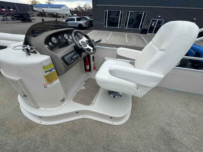 Slide: The Image of Captain's chair and helm of 2007 Premier Grand Majestic 22 boat, featuring steering wheel and gauges. - 13