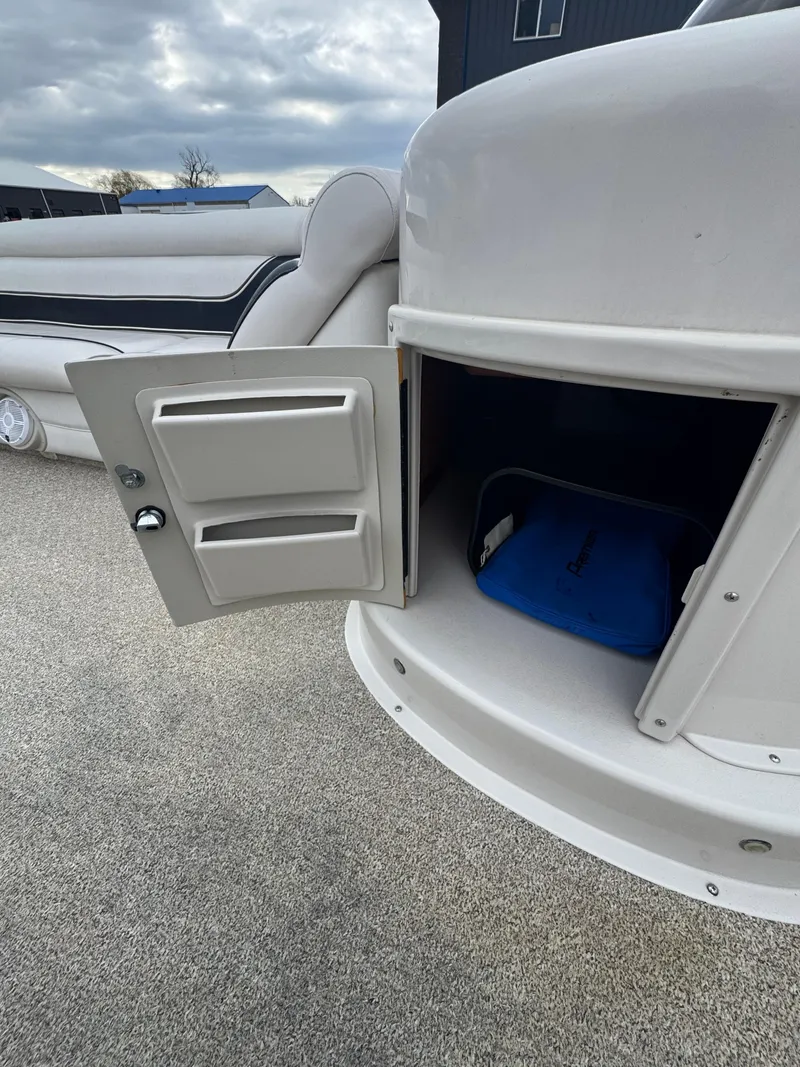 Slide: The Image of Open storage compartment on 2007 Premier Grand Majestic 22 boat, with blue bag inside. - 14