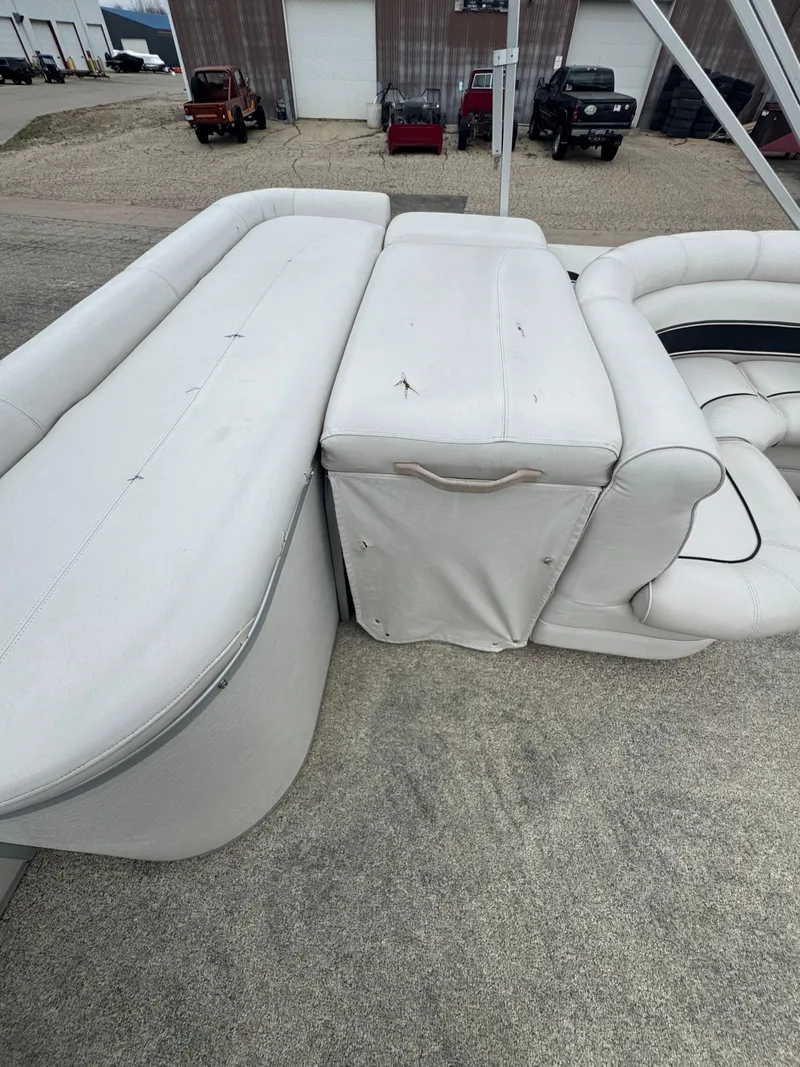 Slide: The Image of 2007 Premier Grand Majestic 22 boat interior with white seating and storage compartment. - 17