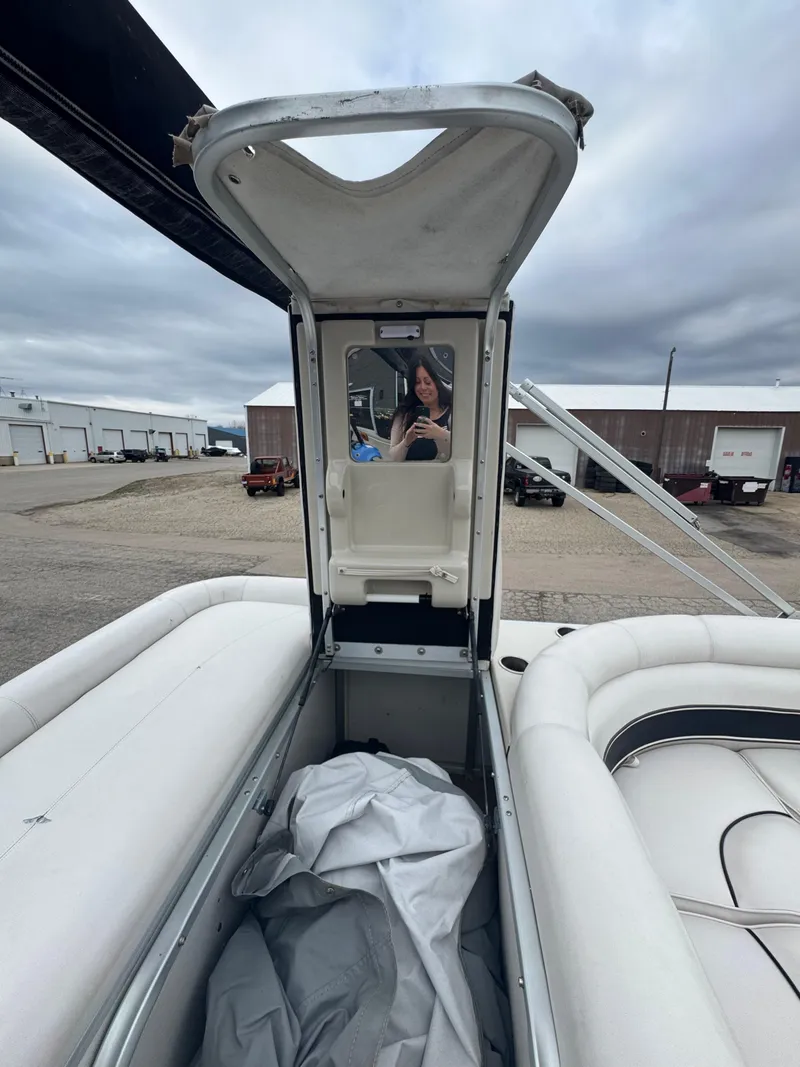 Slide: The Image of 2007 Premier Grand Majestic 22 boat interior with open hatch and person taking a photo. - 18