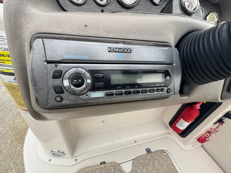 Slide: The Image of Kenwood stereo system in 2007 Premier Grand Majestic 22 boat dashboard. - 23