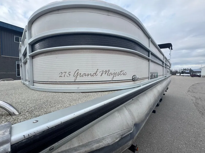 Slide: The Image of 2007 Premier Grand Majestic 22 pontoon boat parked on pavement. - 3