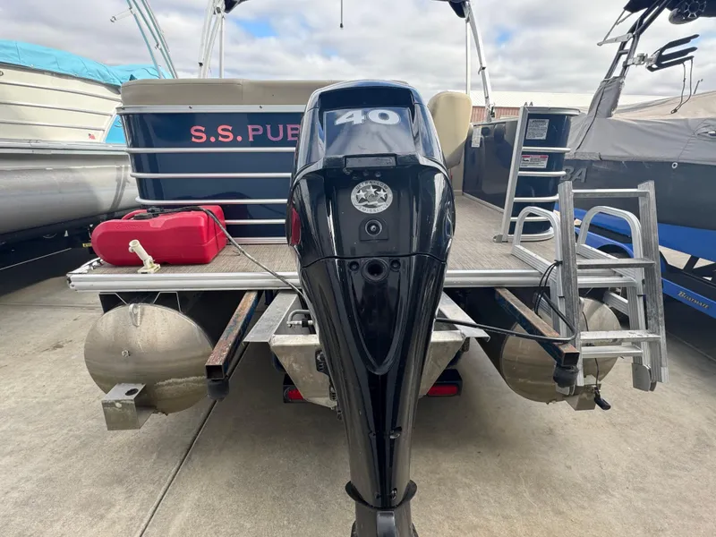 Slide: The Image of 2017 Sylvan Mirage 818 Cruiser with outboard motor and ladder, docked on concrete. - 12