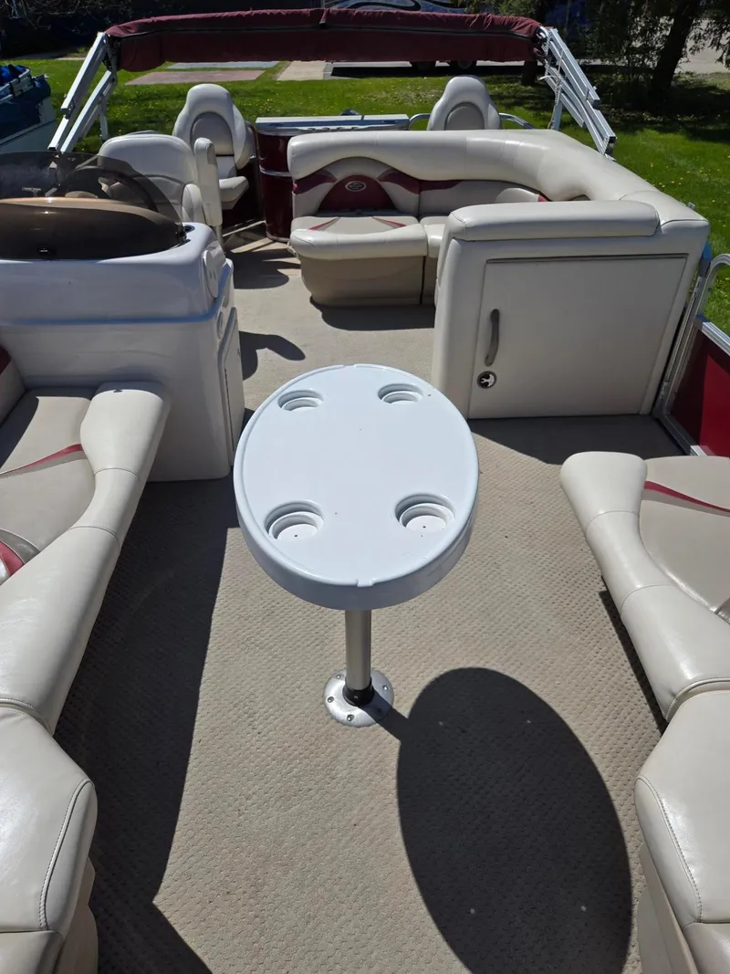 Slide: The Image of 2011 Sylvan Mirage 8520 pontoon boat interior with seating and table. - 13