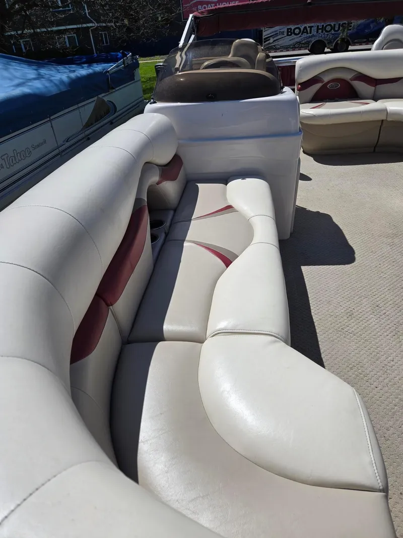 Slide: The Image of 2011 Sylvan Mirage 8520 boat interior with white and red seating. - 14
