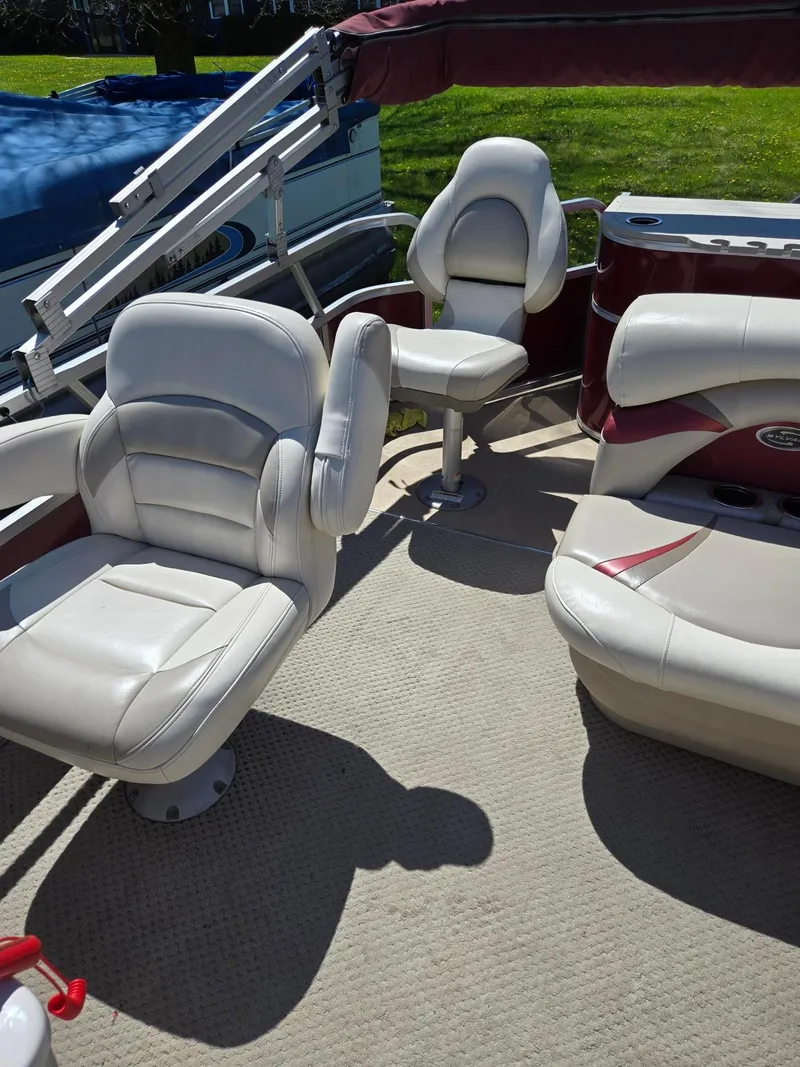 Slide: The Image of 2011 Sylvan Mirage 8520 boat interior with white leather seats and red accents. - 19