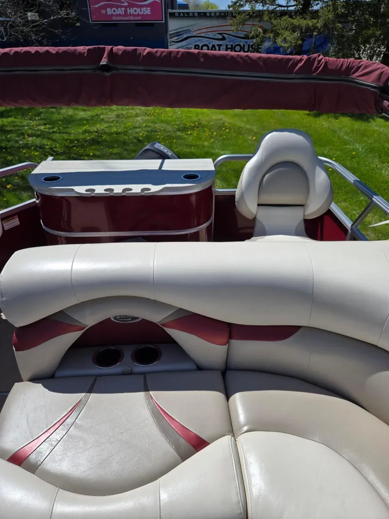 Slide: The Image of 2011 Sylvan Mirage 8520 boat interior with plush seating and cup holders. - 20