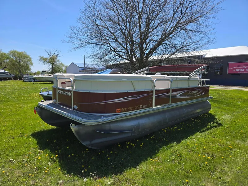 Slide: The Image of 2011 Sylvan Mirage 8520 pontoon boat on grassy field under clear blue sky. - 3
