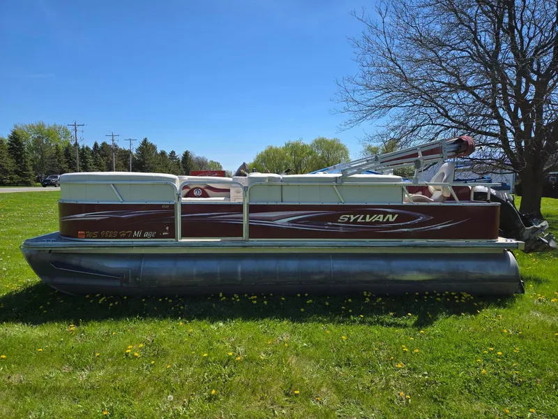 Slide: The Image of 2011 Sylvan Mirage 8520 pontoon boat on grassy field under clear blue sky. - 4