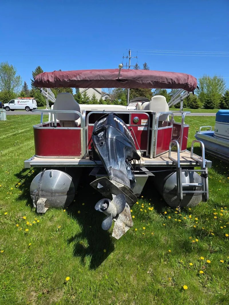 Slide: The Image of 2011 Sylvan Mirage 8520 pontoon boat with canopy, parked on grass. - 5