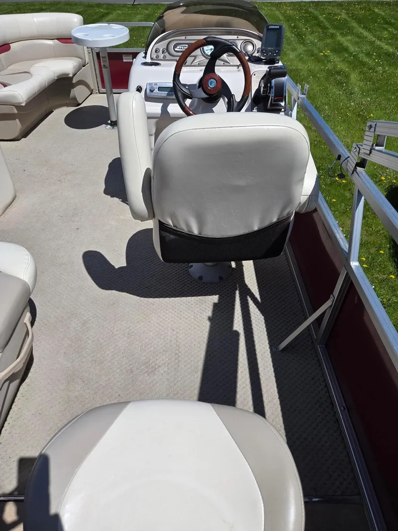 Slide: The Image of Interior of a 2011 Sylvan Mirage 8520 pontoon boat with seating and steering console. - 7