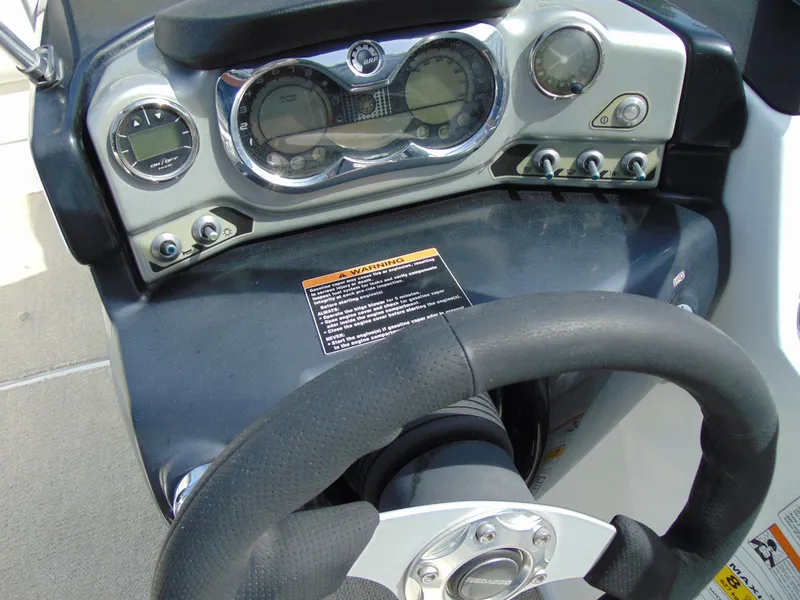 Slide: The Image of Dashboard of 2011 Sea-Doo 180 Challenger SE boat with steering wheel and gauges. - 11
