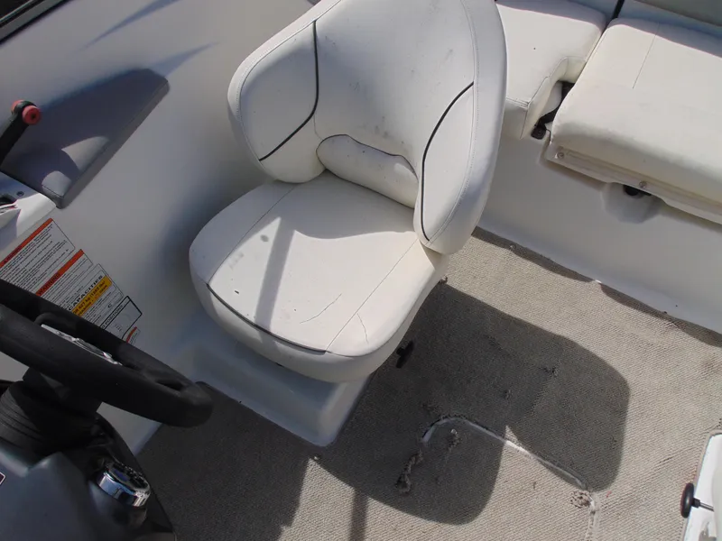 Slide: The Image of 2011 Sea-Doo 180 Challenger SE boat interior with white seating and steering wheel. - 20