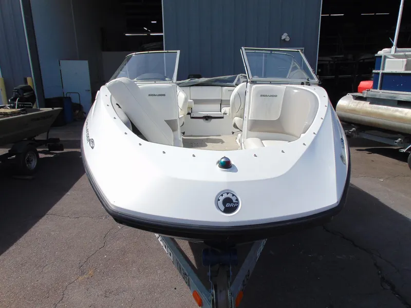 Slide: The Image of 2011 Sea-Doo 180 Challenger SE boat, white exterior, parked on trailer. - 23