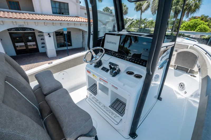 Slide: The Image of 2025 Sea Hunt Gamefish 25 boat interior with Garmin navigation system and comfortable seating. - 19