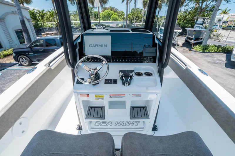 Slide: The Image of 2025 Sea Hunt Gamefish 25 boat console with Garmin navigation system and steering wheel. - 17