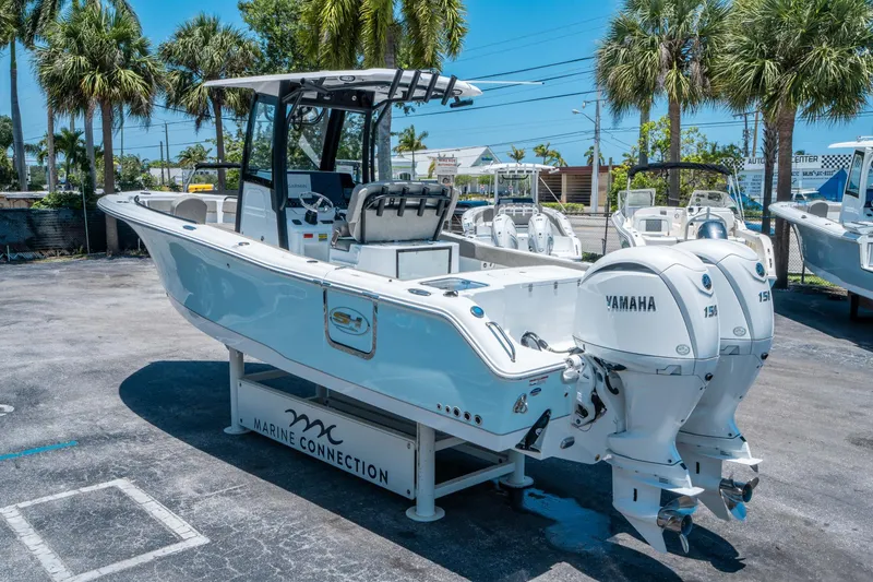 Slide: The Image of 2025 Sea Hunt Gamefish 25 boat with dual Yamaha engines, displayed outdoors. - 4