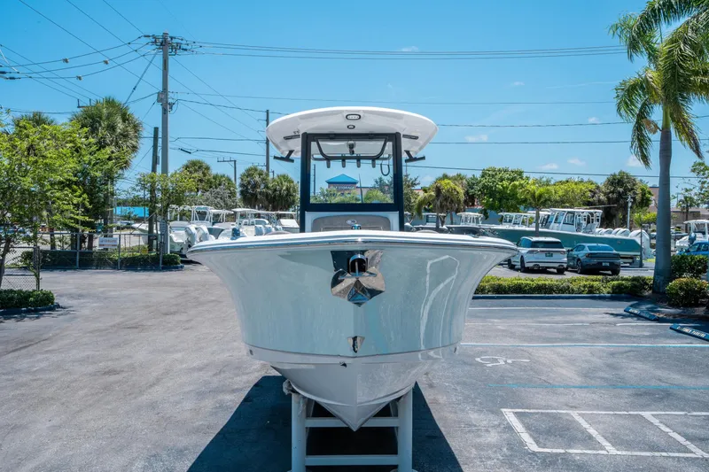Slide: The Image of 2025 Sea Hunt Gamefish 25 boat displayed in a parking lot under clear blue skies. - 7