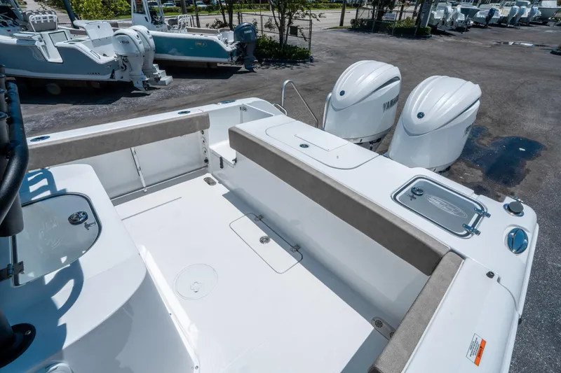 Slide: The Image of 2025 Sea Hunt Gamefish 25 boat with dual Yamaha engines, spacious deck, and seating area. - 12