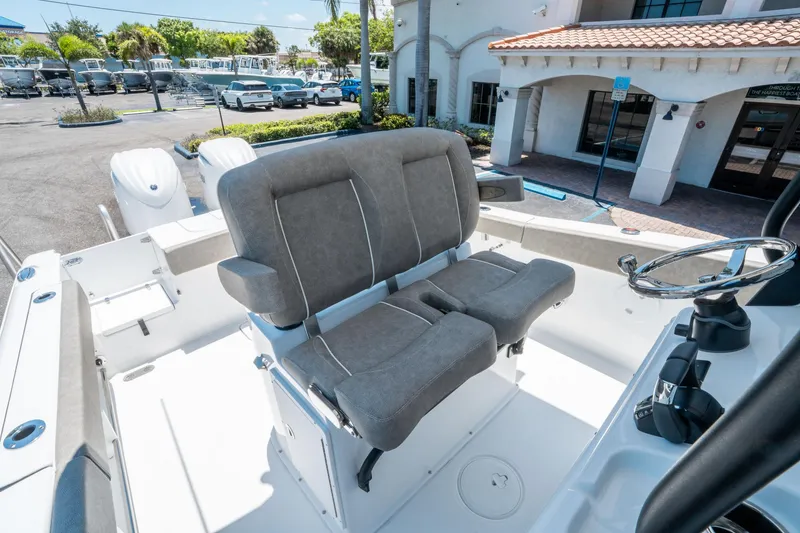 Slide: The Image of 2025 Sea Hunt Gamefish 25 boat interior with dual seats and steering wheel. - 22