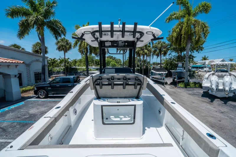 Slide: The Image of 2025 Sea Hunt Gamefish 25 boat, spacious deck, palm trees, sunny day. - 9