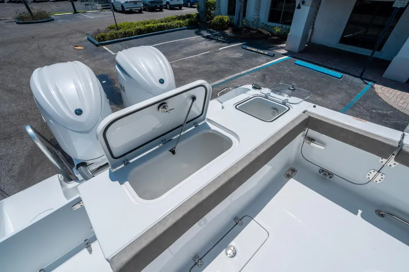 Slide: The Image of 2025 Sea Hunt Gamefish 25 boat with open storage compartment and twin engines. - 13