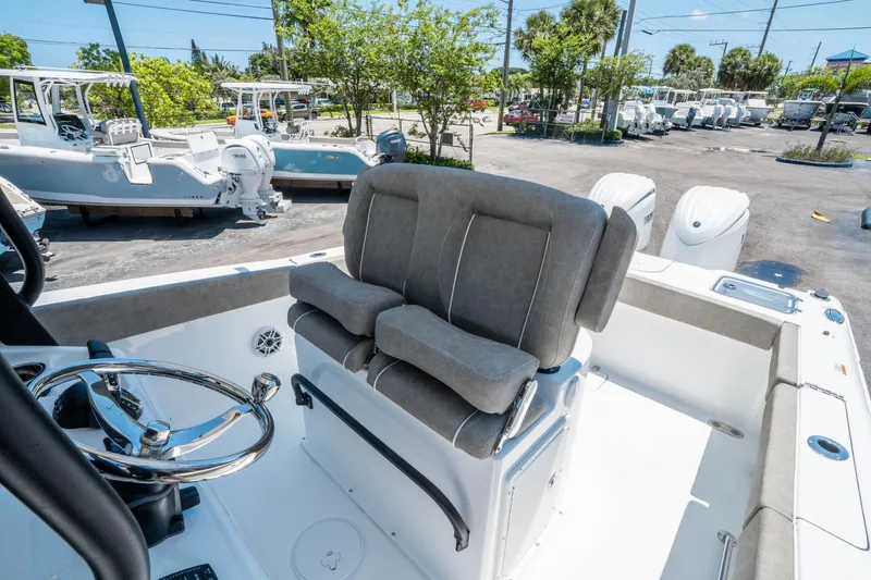 Slide: The Image of 2025 Sea Hunt Gamefish 25 boat interior with cushioned seating and steering wheel. - 20