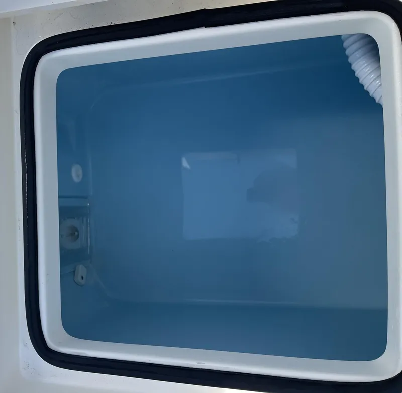 Slide: The Image of Open storage compartment on 2025 Pathfinder 2300 HPS boat. - 18