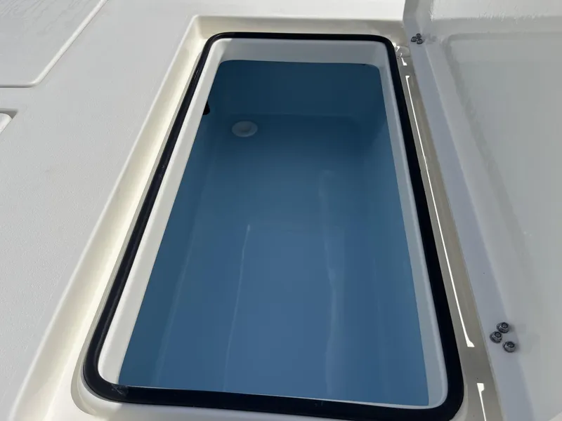 Slide: The Image of Open storage compartment on 2025 Pathfinder 2300 HPS boat, featuring a sleek design. - 19