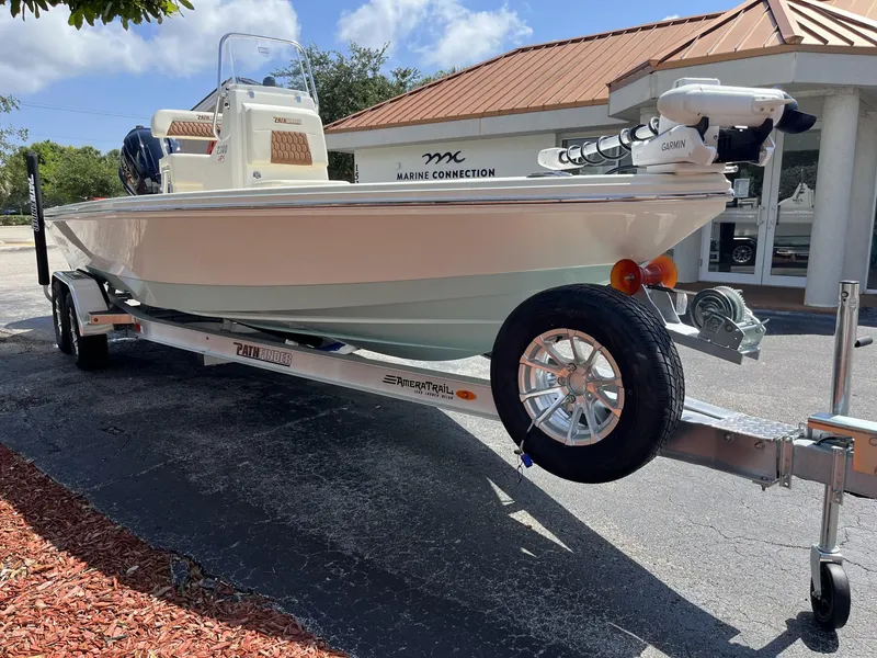 Slide: The Image of 2025 Pathfinder 2300 HPS boat on trailer, parked outside Marine Connection dealership. - 24