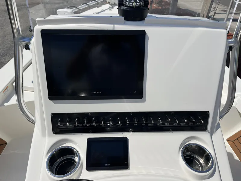 Slide: The Image of 2025 Pathfinder 2300 HPS boat console with Garmin display and control panel. - 11