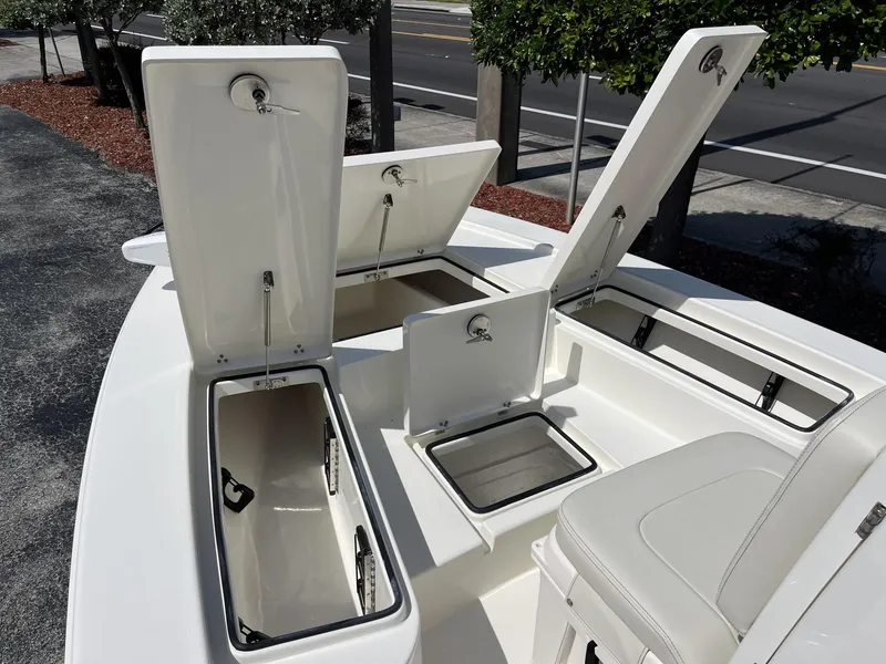 Slide: The Image of 2025 Pathfinder 2300 HPS boat with open storage compartments and seating. - 14