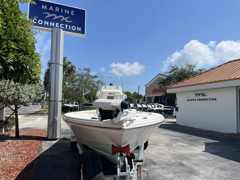 Slide: The Image of 2025 Pathfinder 2300 HPS boat at Marine Connection dealership under clear blue sky. - 3