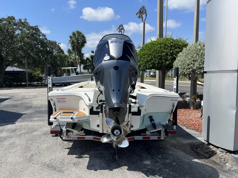 Slide: The Image of 2025 Pathfinder 2300 HPS boat with powerful outboard motor, parked outdoors. - 5